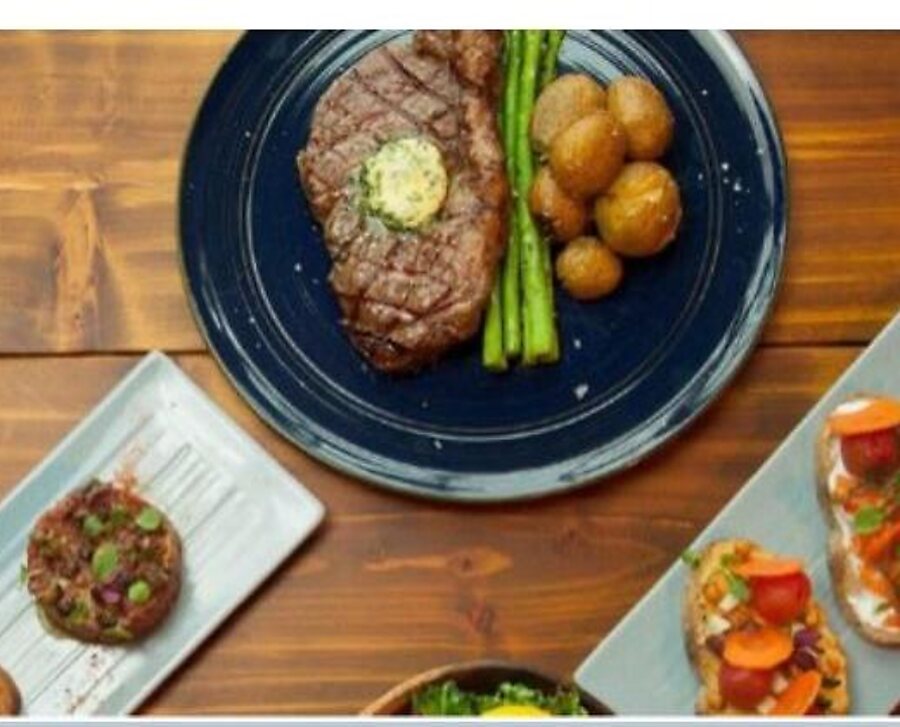 Grilled steak with herb butter, asparagus and potatoes