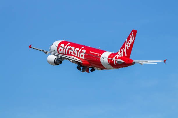 AirAsia jet climbing into a blue sky