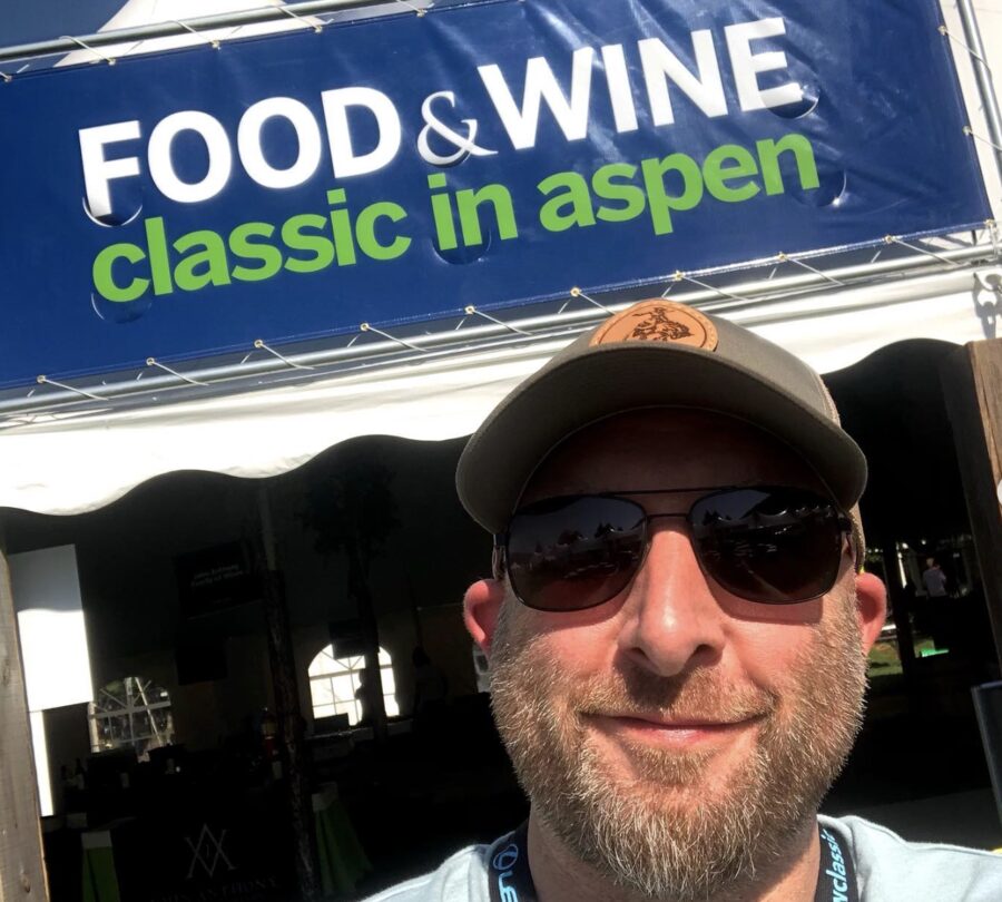 Scott Robinson under the Food and Wine Classic in Aspen tent banner