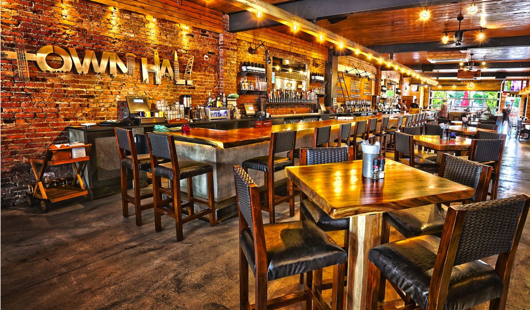 Long wooden bar inside an Ethos property